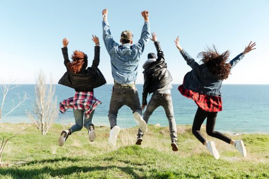 back-view-picture-of-group-of-friends-jumping