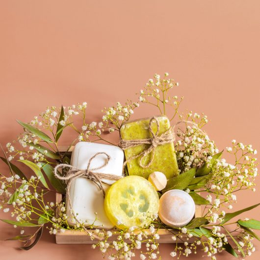 spa-body-care-accessories-wooden-box-colored-background