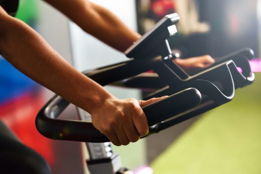 woman-gym-doing-spinning-cyclo-indoor-with-smart-watch